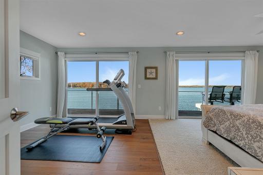 Now that's a view worth waking up to! Two sets of sliding glass doors showcase sweeping water views and bring the beauty of the outdoors right into the primary bedroom.
