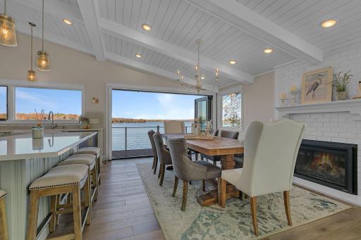 The open-concept main level features vaulted ceilings with painted white beams and tongue-and-groove detailing, a gas fireplace, and a beautifully remodeled kitchen with quartz countertops and center island.