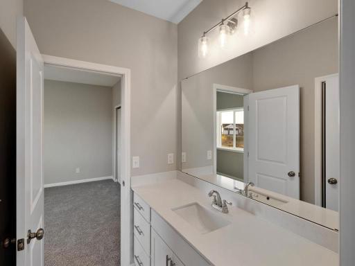 PHOTO OF A DIFFERENT HOME WITH SIMILAR PLAN. FINISHES MAY VARY. Jack n Jill Bath serves bedrooms 2 and 3.