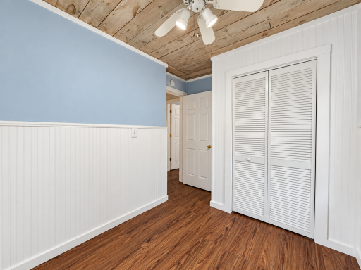 Brightened blue-gray bedroom with louvered closet-6.png