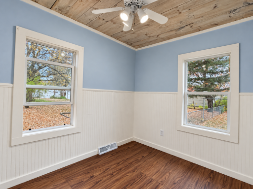Brightened bedroom corner with two windows-10.png