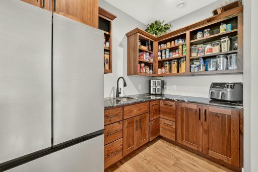 Huge pantry offers another refrigerator and food prep area.