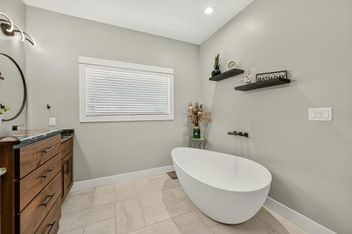 Classy tub in this primary bath with heated ceramic tile flooring.