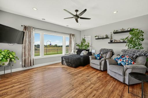 Huge windows offer an abundance of natural light in this second living area.