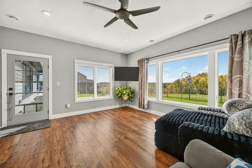 Second living area with door to the fenced area behind the home.