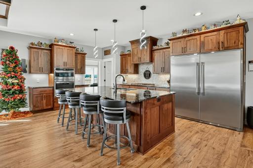 Huge kitchen with double stainless refrigerator and huge island.