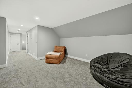 Upper level bonus area with carpet and recessed lighting.