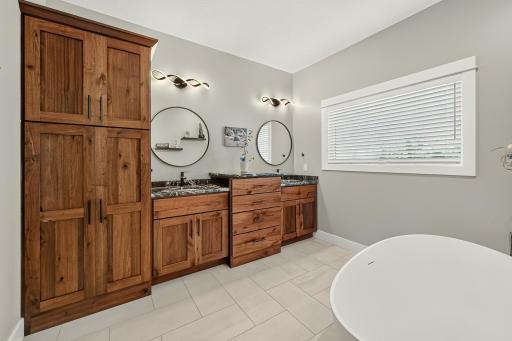 Primary bath with separate double-sinks and lots of storage.