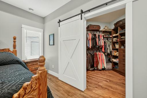 Sliding barn door opens to a huge closet with built-ins.