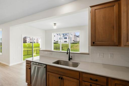 The kitchen sink overlooks the backyard, allowing you to enjoy outdoor views while preparing meals or cleaning up.