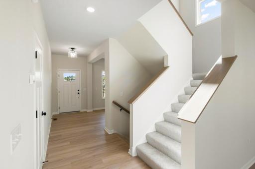 Inviting hallway with warm wood flooring welcomes you inside.
