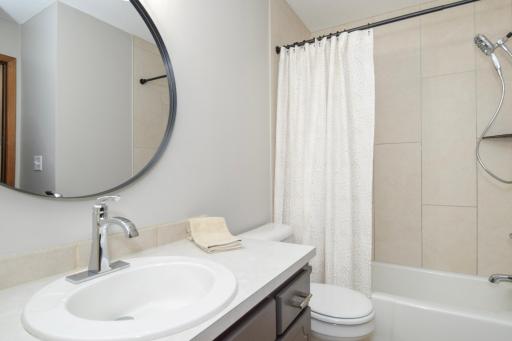 This STUNNING Bath Update Must Be Seen to Appreciate!!! The Tile is Textured and Terrific! BRAND NEW DELTA FIXTURES TOO! Couple Other New Bonuses Here...Come See!