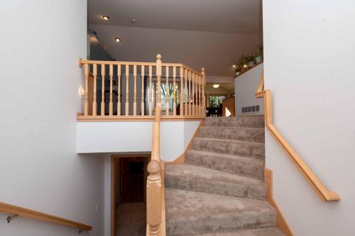 An open staircase leads to the main living area.