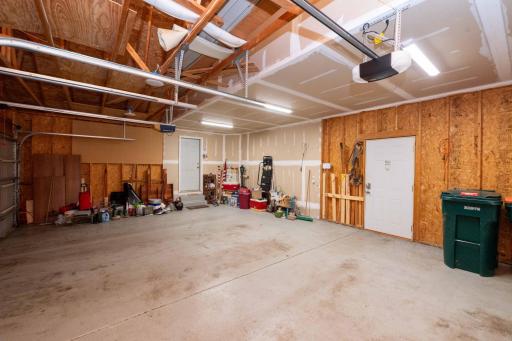 Attached three-car garage with room for vehicles, tools, and storage.