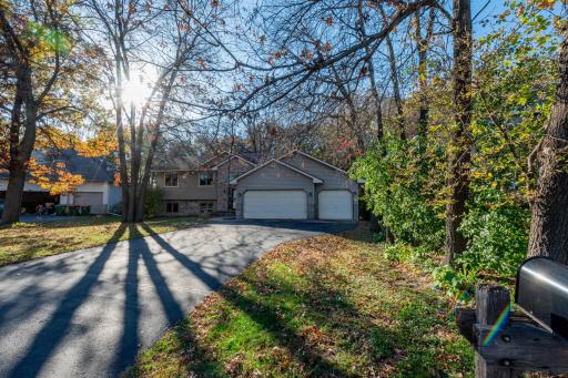 Situated near the end of a quiet street, with mature trees framing the home.