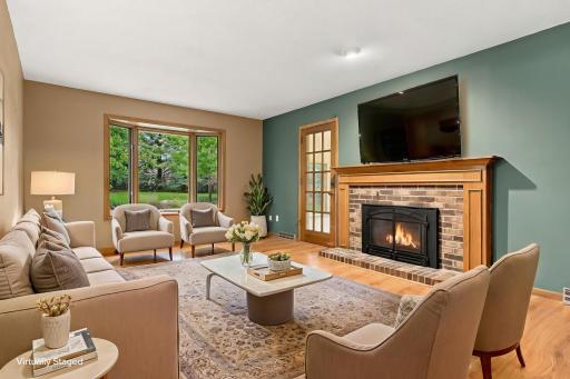 Virtually staged living room overlooking the backyard