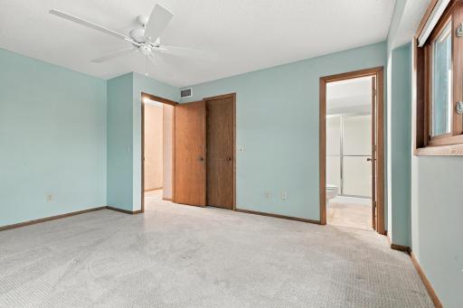 Primary bedroom with walk in closet and laundry shoot