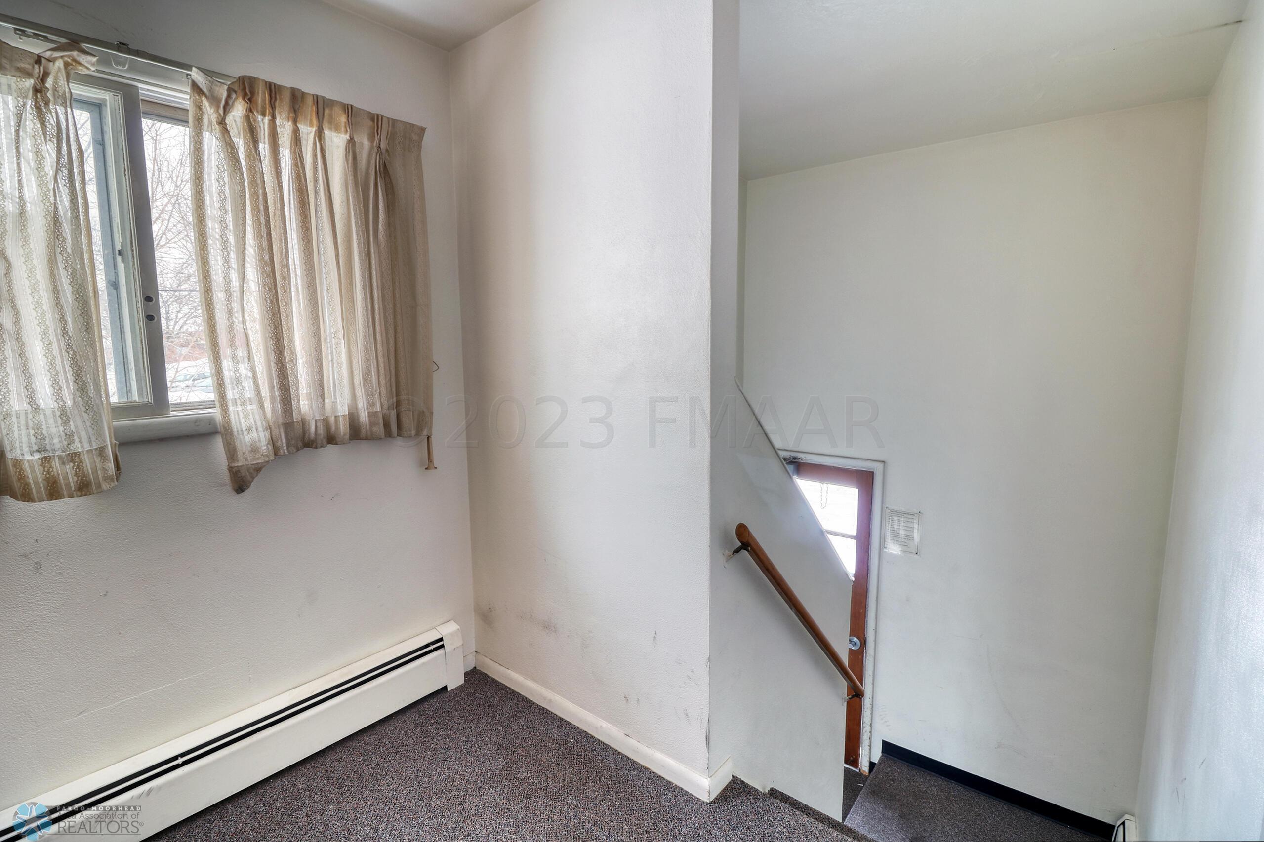 Rear Staircase leading to backdoor