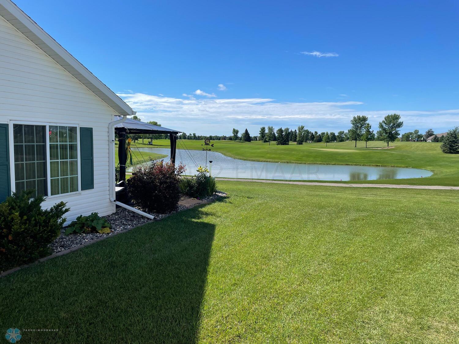 Side yard view to golf course pond