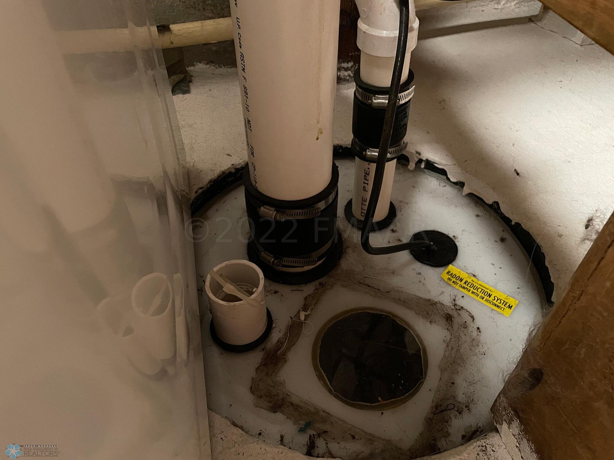 Radon mitigation system connected to sum