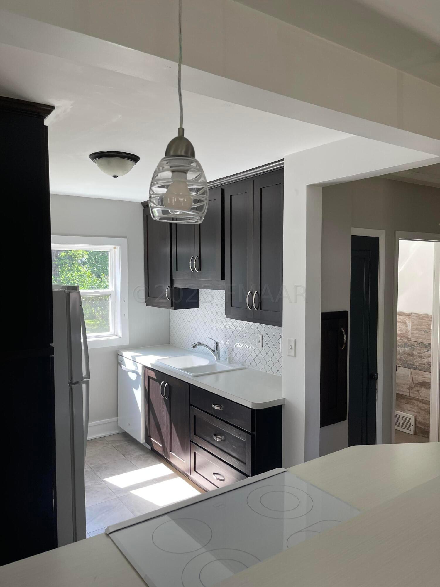 Kitchen from bar top with stove