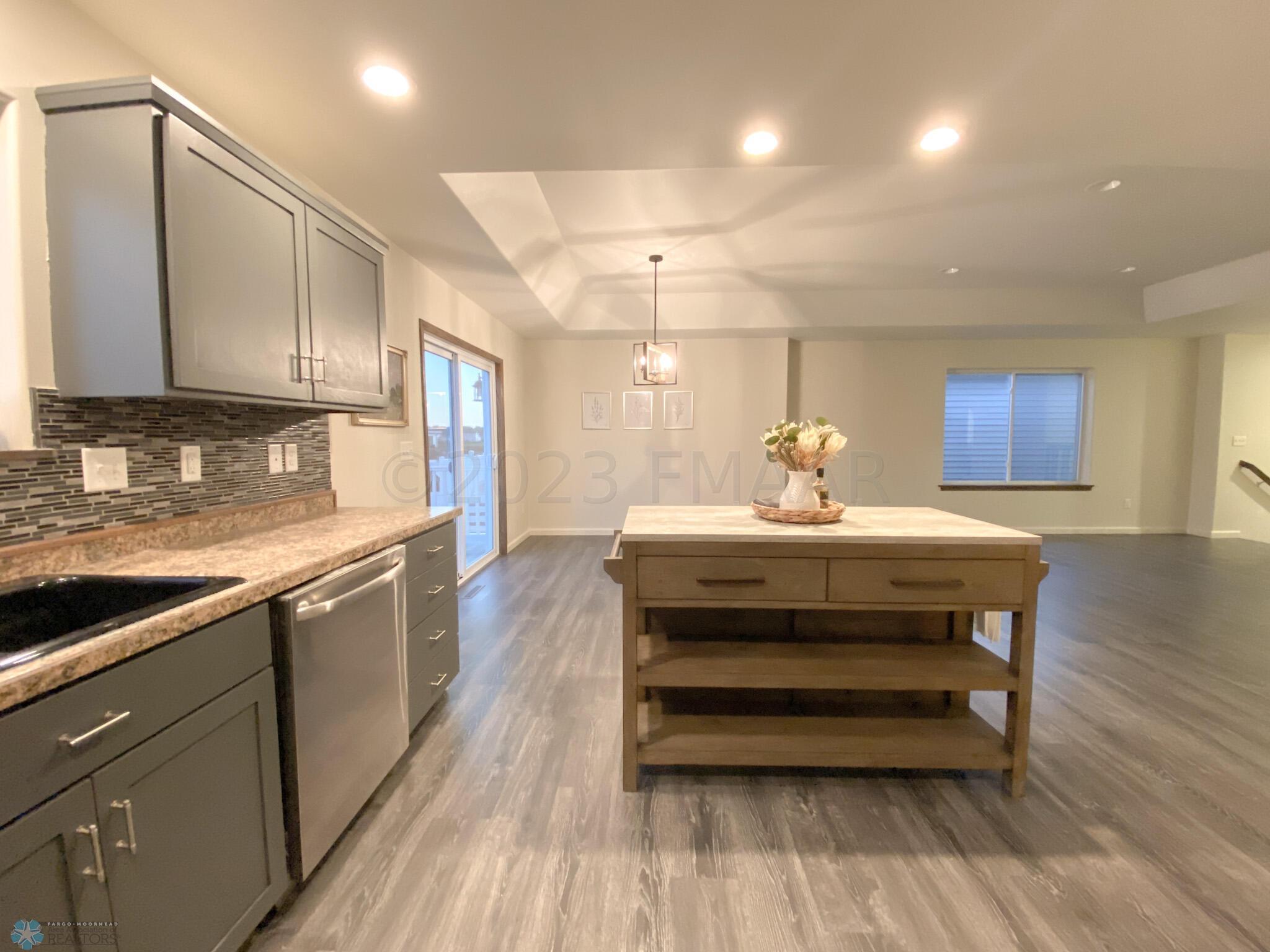 KITCHEN OVERLOOKING DINING AND LIVING AR