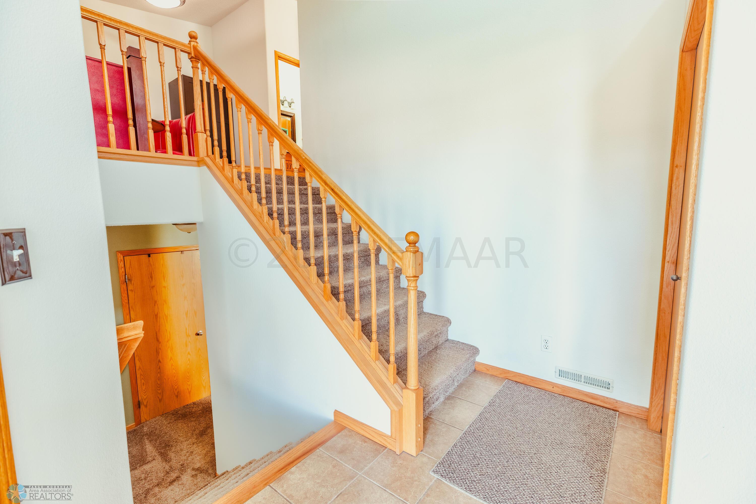 Tiled large entryway with coat closet