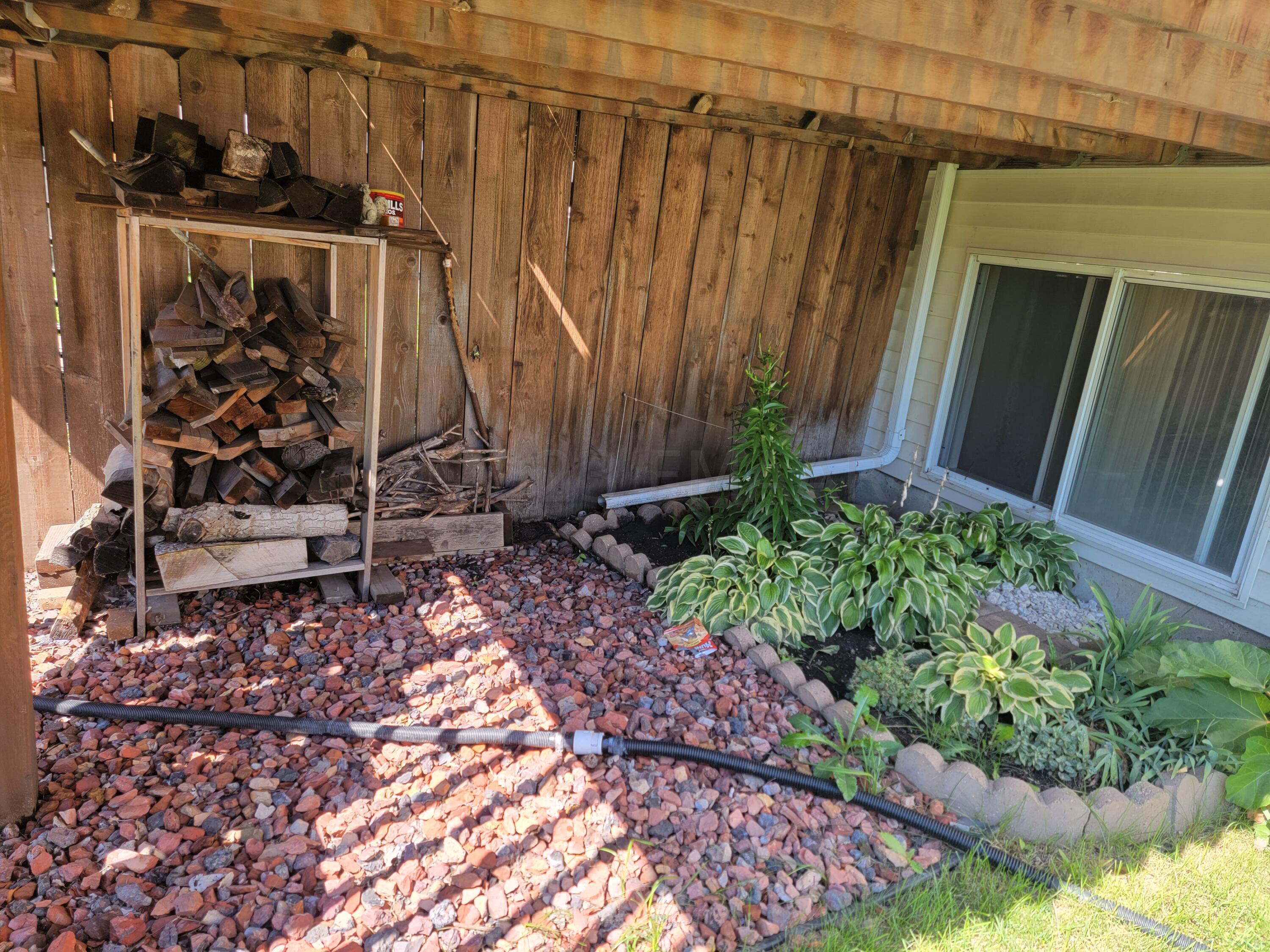 Perennials & wood under deck