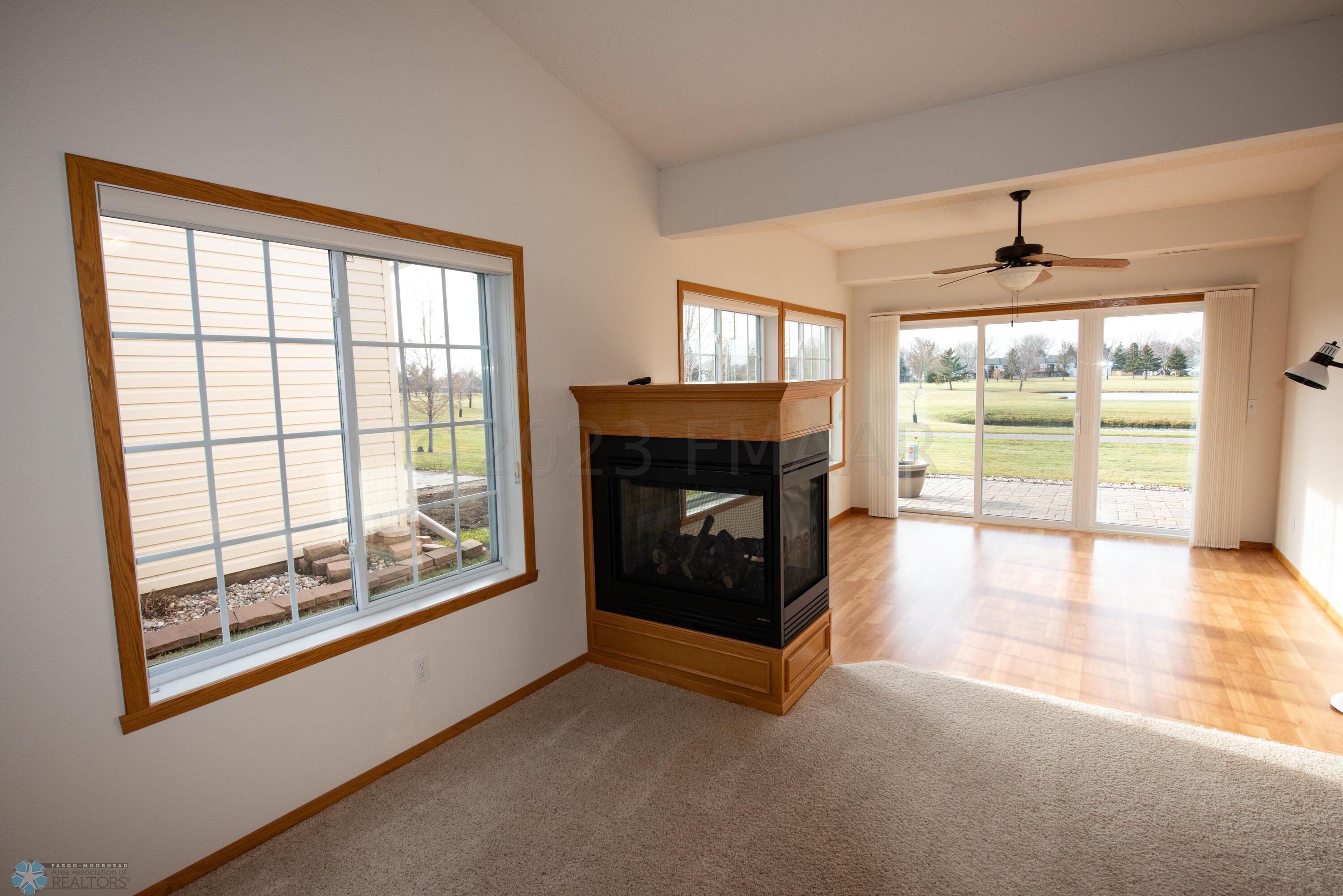 living room to sun room + fireplace
