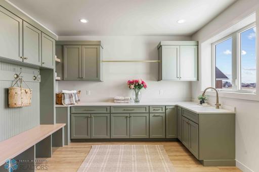 Laundry Room w/ Hanging Rack and Cabinets