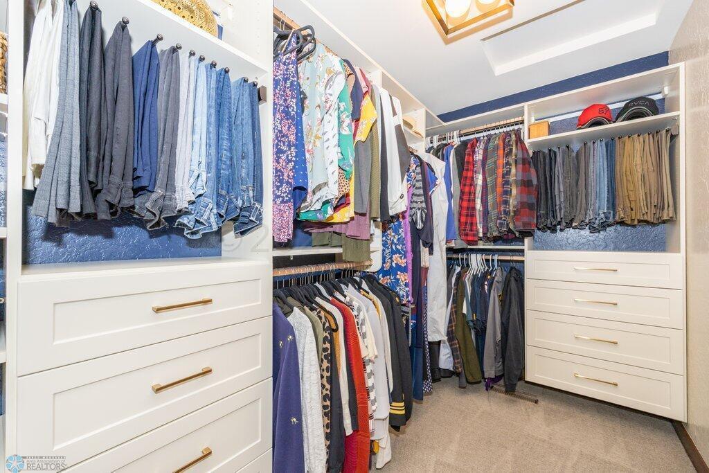 Primary walk-in closet with new shelving